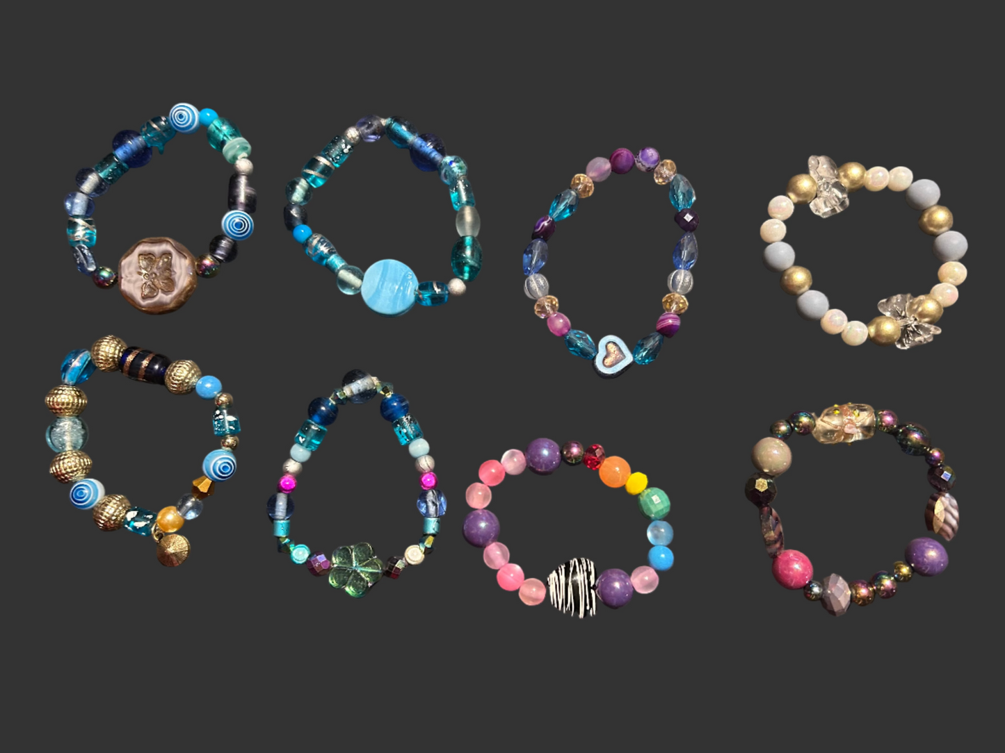 Collection of beaded bracelets on a dark surface