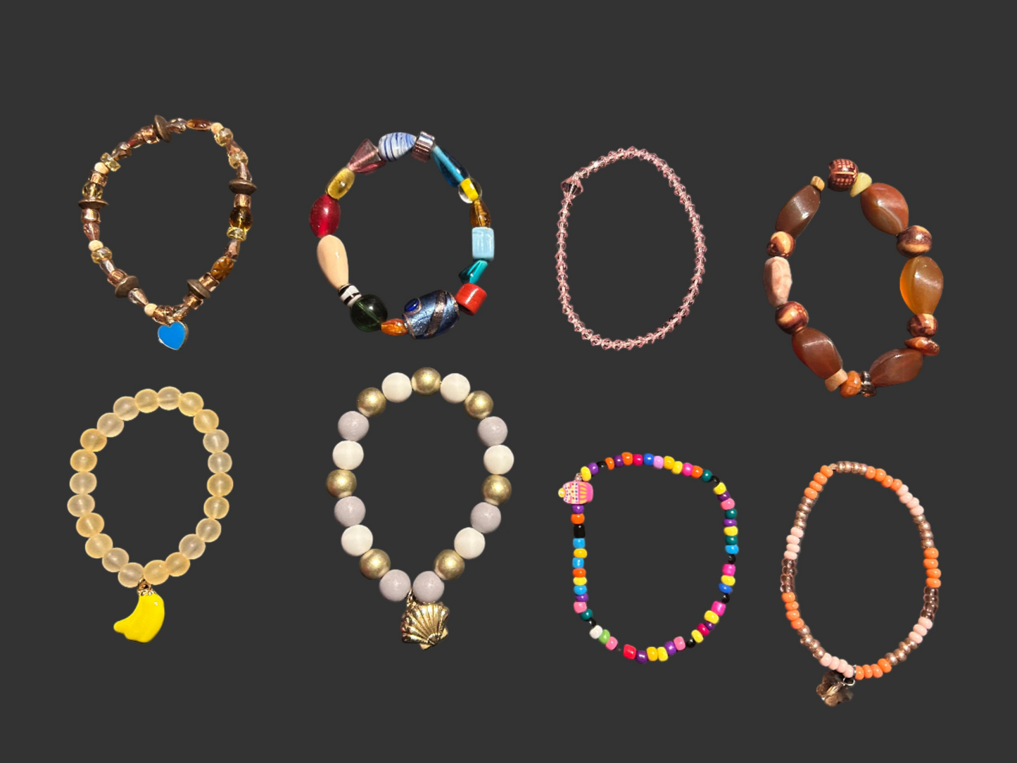 Collection of various beaded bracelets on a dark surface